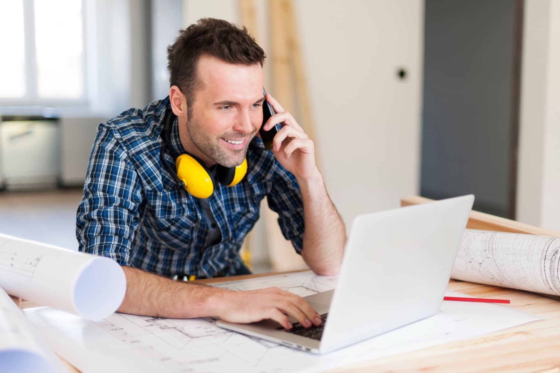 US Construction team member reviewing a project on site